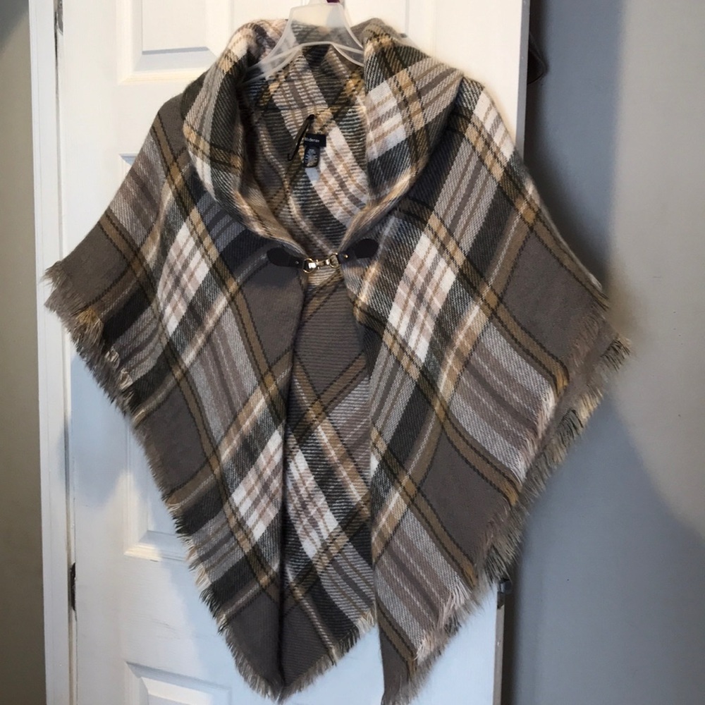 Plaid shawl with attached buckle in front. One size
